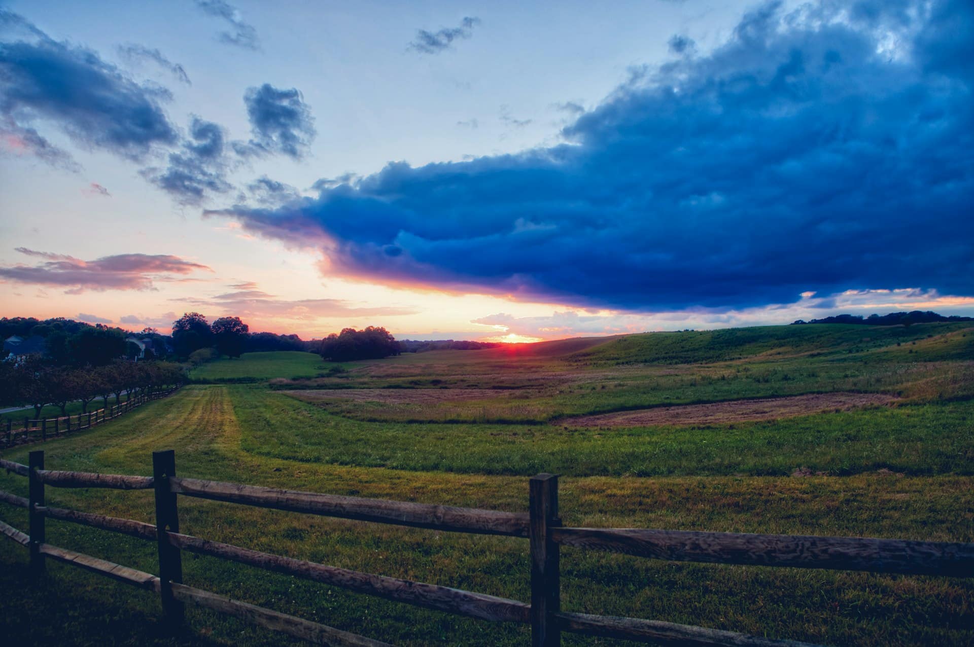 Open ranch pasture with a fence at sunset