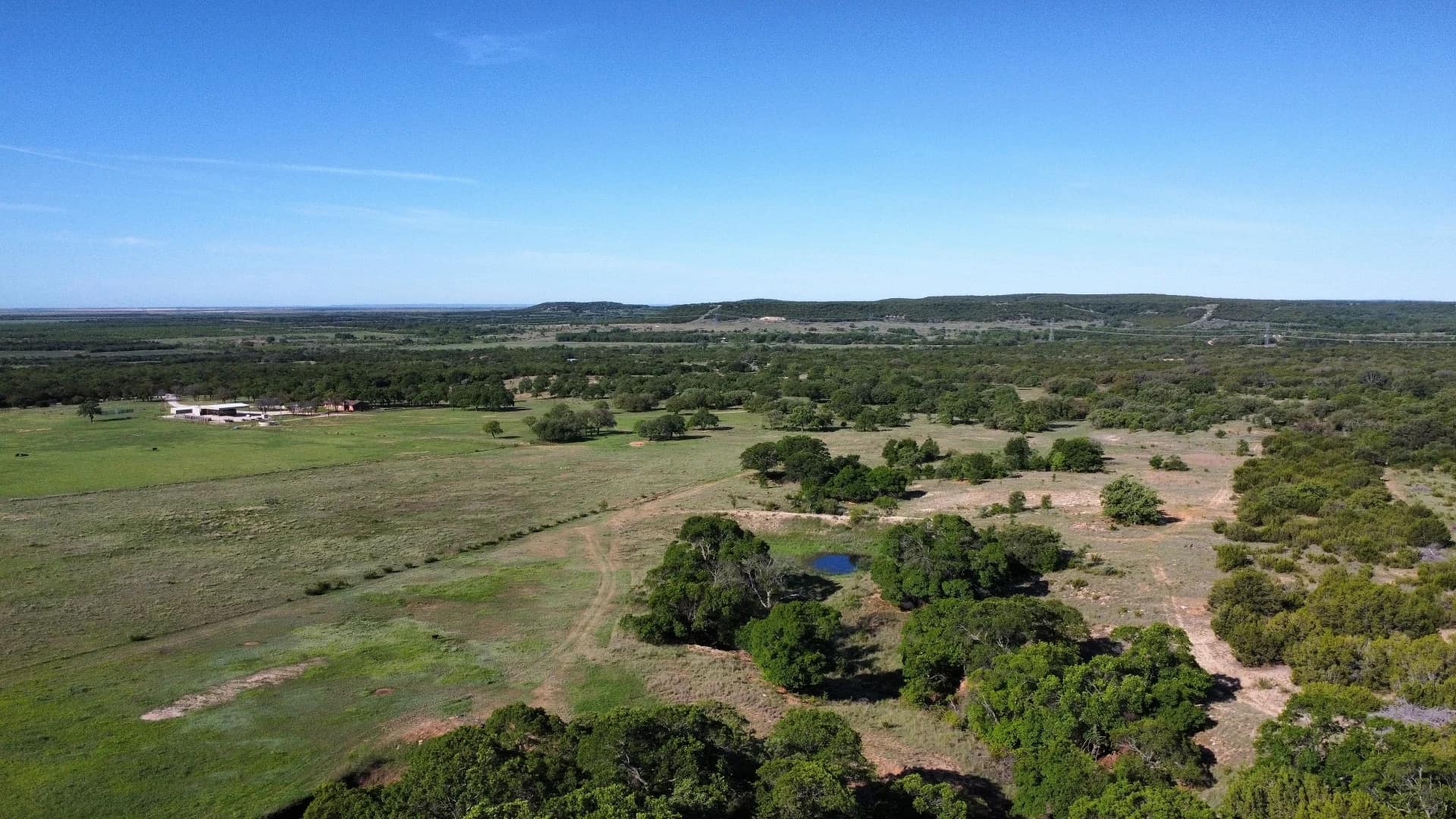 West Texas ranch land with native pasture, mesquite, live oak, draws, and big views